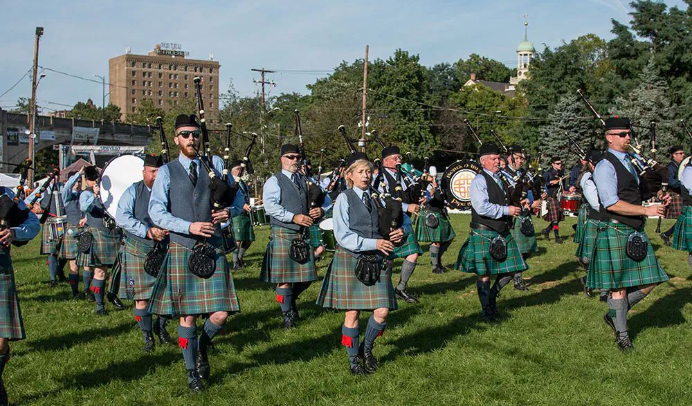 Pipers and drummers marching across a festival field in Bethlehem